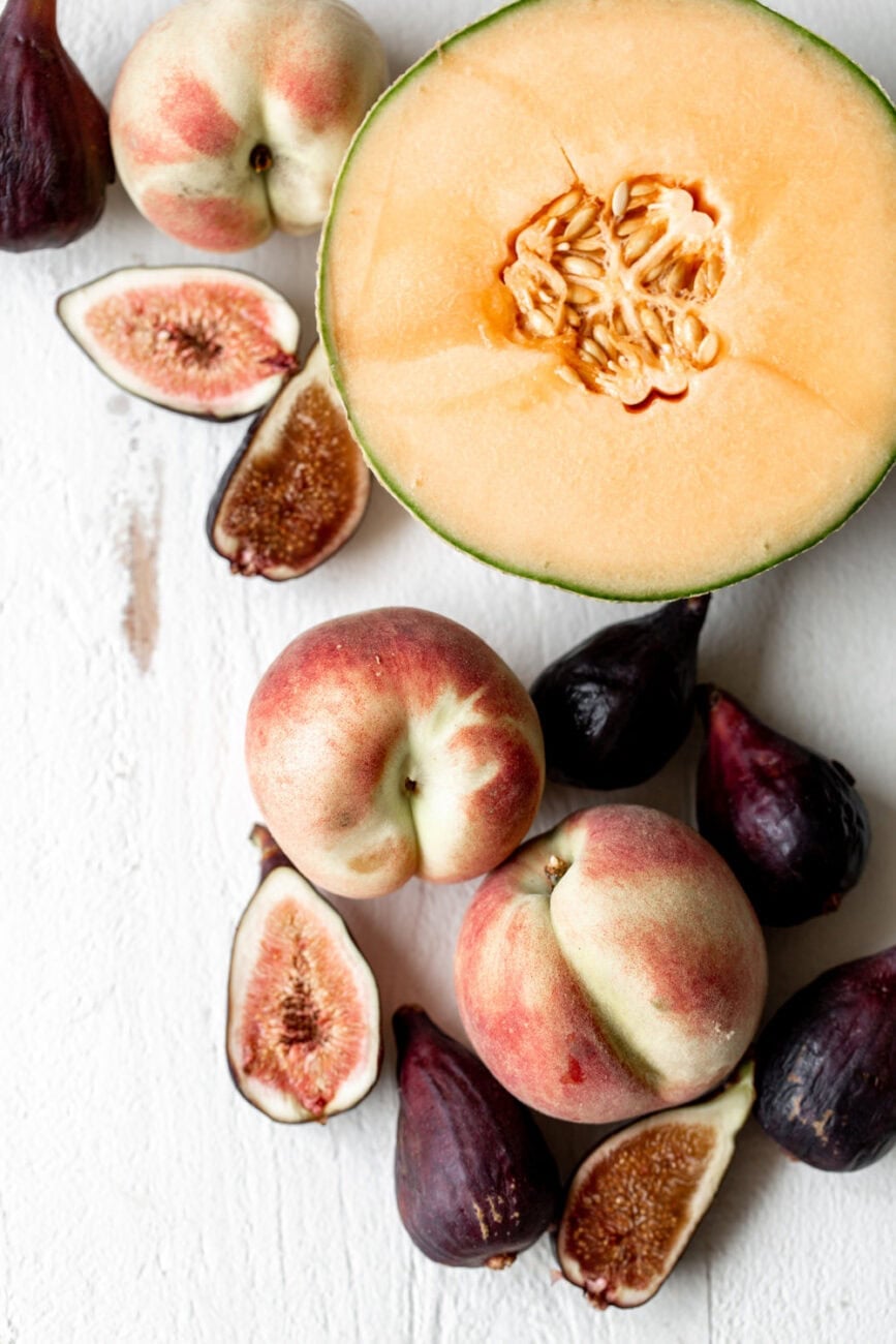 white peaches with cantaloupe and figs.