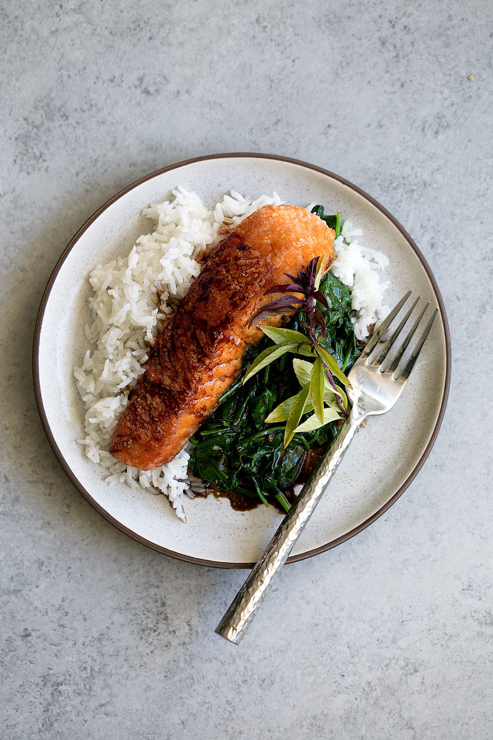crispy salmon with soy tamarind sauce over rice and spinach