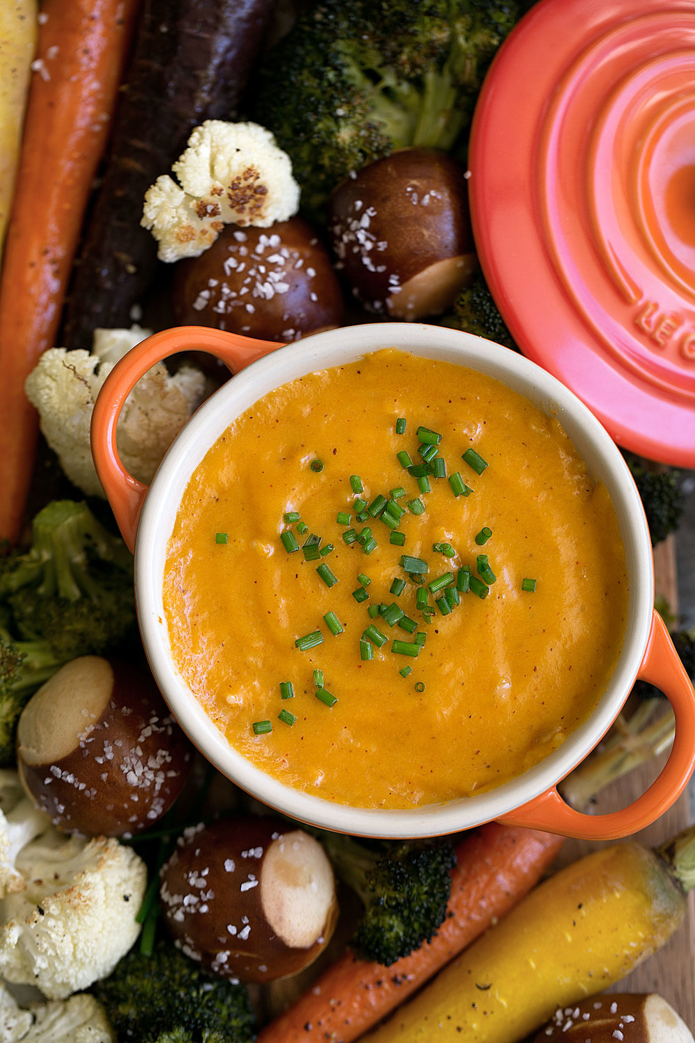This beer cheese fondue recipe is made with Cheddar cheese and seasoned with pilsner beer and Worcestershire accompanied by roasted vegetables