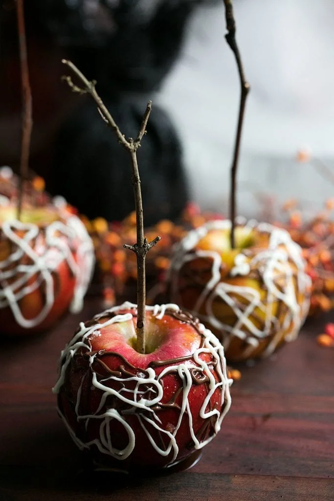 Sea Salt Bourbon Caramel Apples with Spider Web Chocolate.