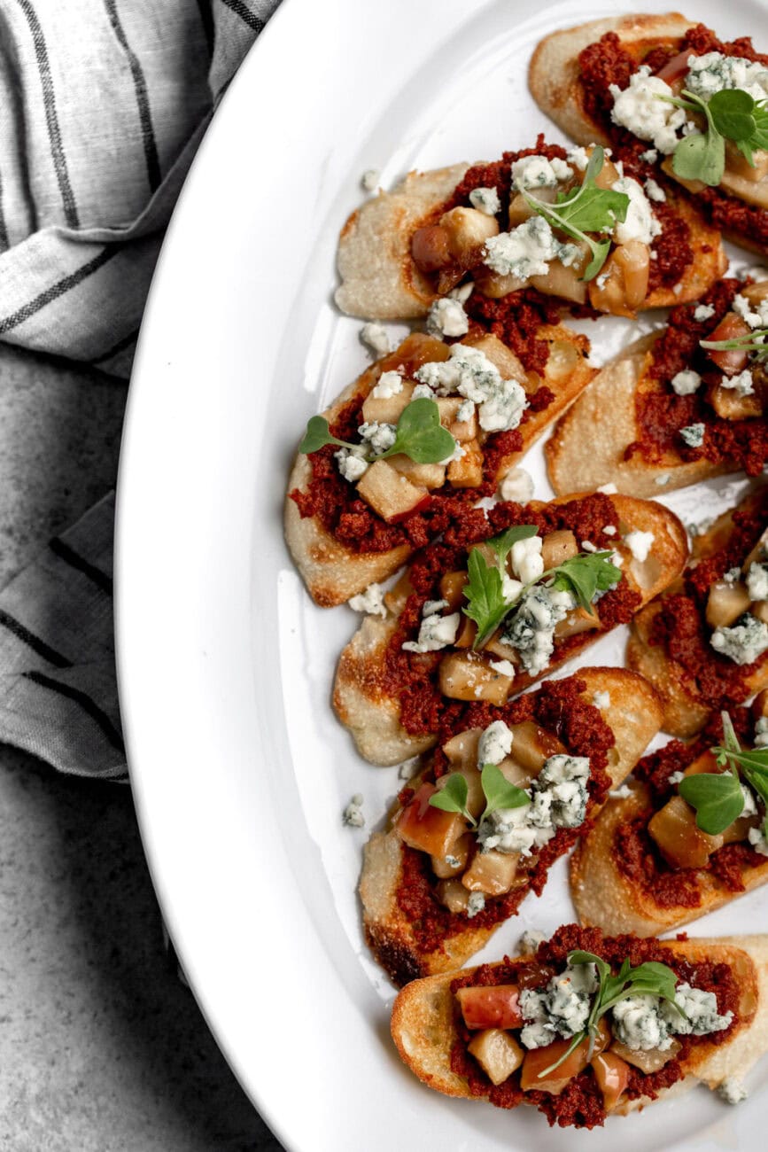 baked brown sugar apples on crostini with chorizo and blue cheese.