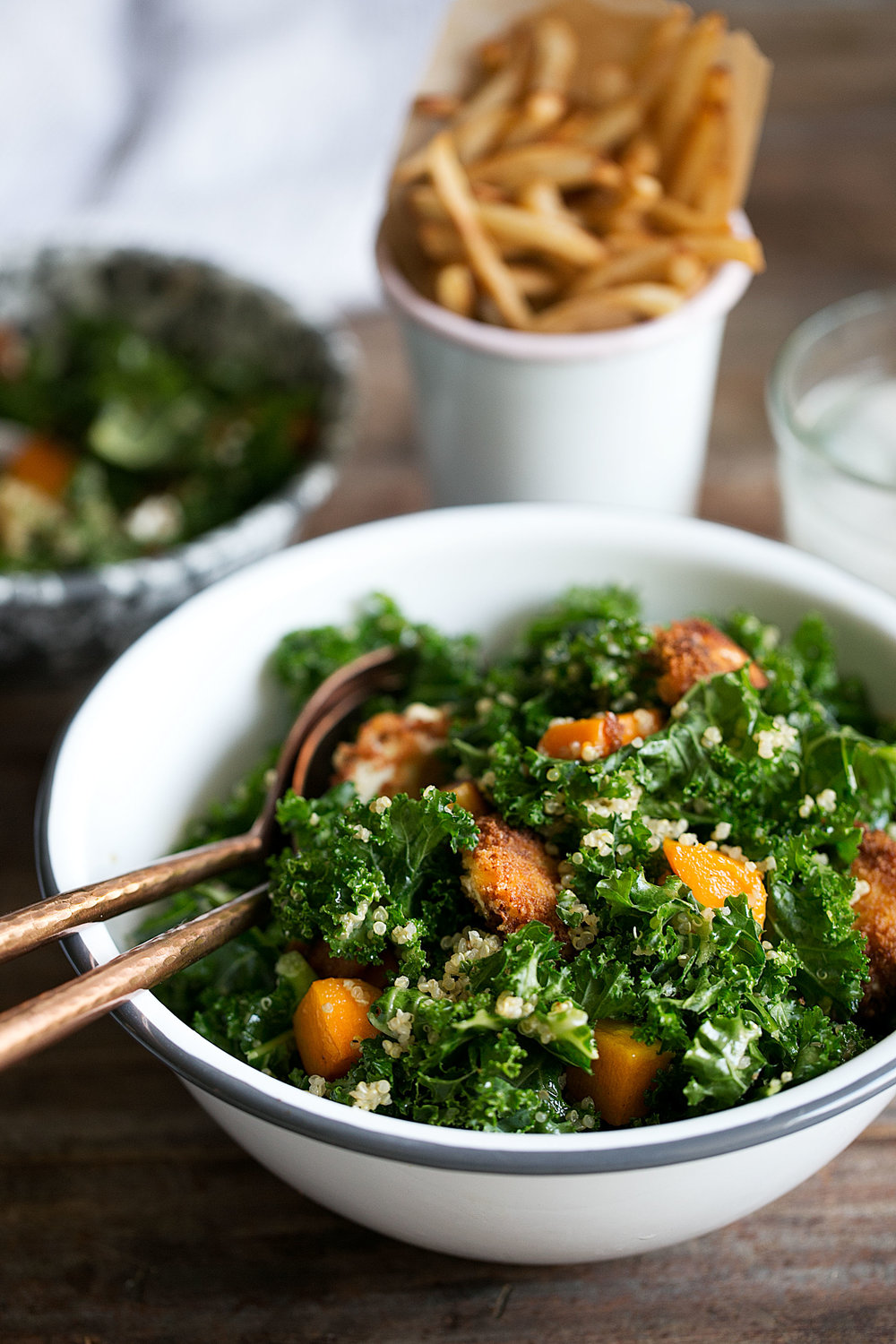 Butternut Squash, Quinoa & Kale Salad with Warm Goat Cheese and Apple Cider Vinaigrette in salad bowl