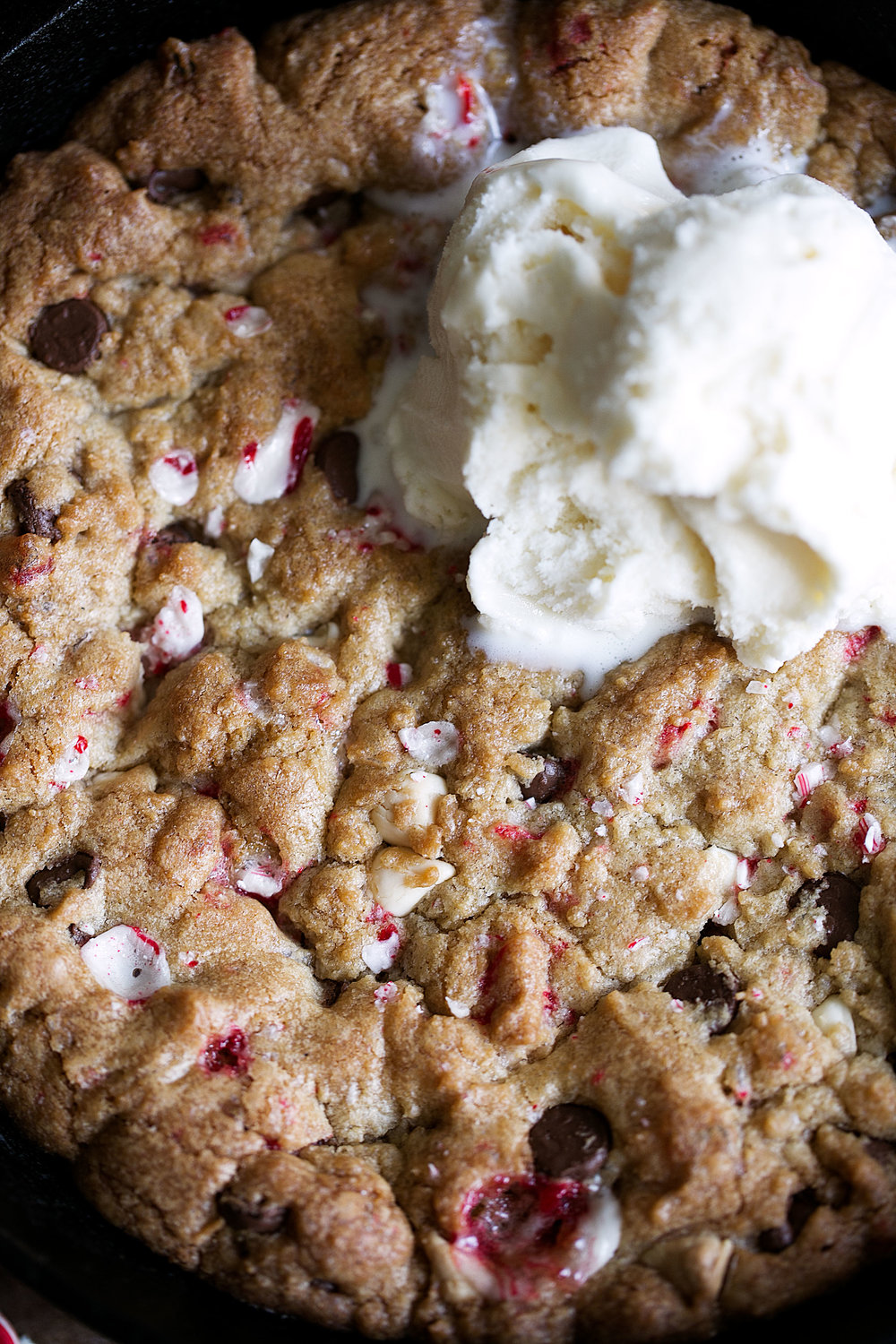 closeup peppermint mixed chocolate chip skillet pizookie with vanilla ice cream