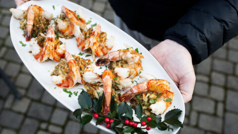baked stuffed shrimp with crabmeat filling on white platter.