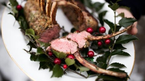 rosemary thyme rack of lamb holiday cooking with holly and cranberries.