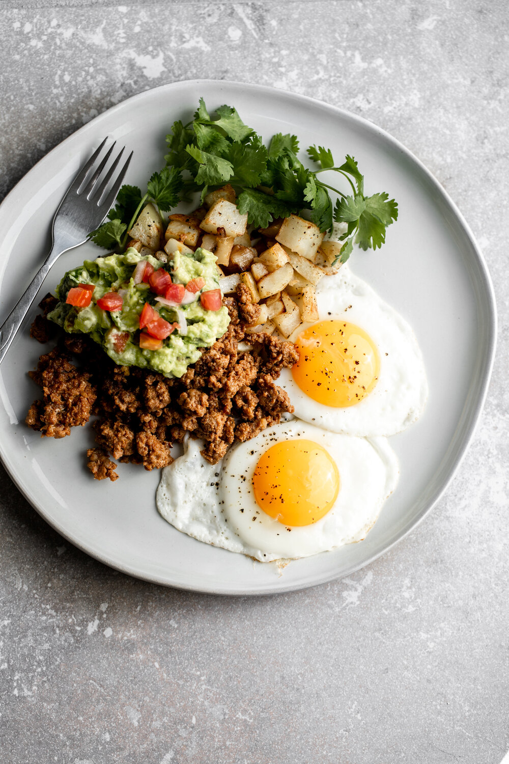 dad's breakfast potatoes with chorizo and eggs with guacamole