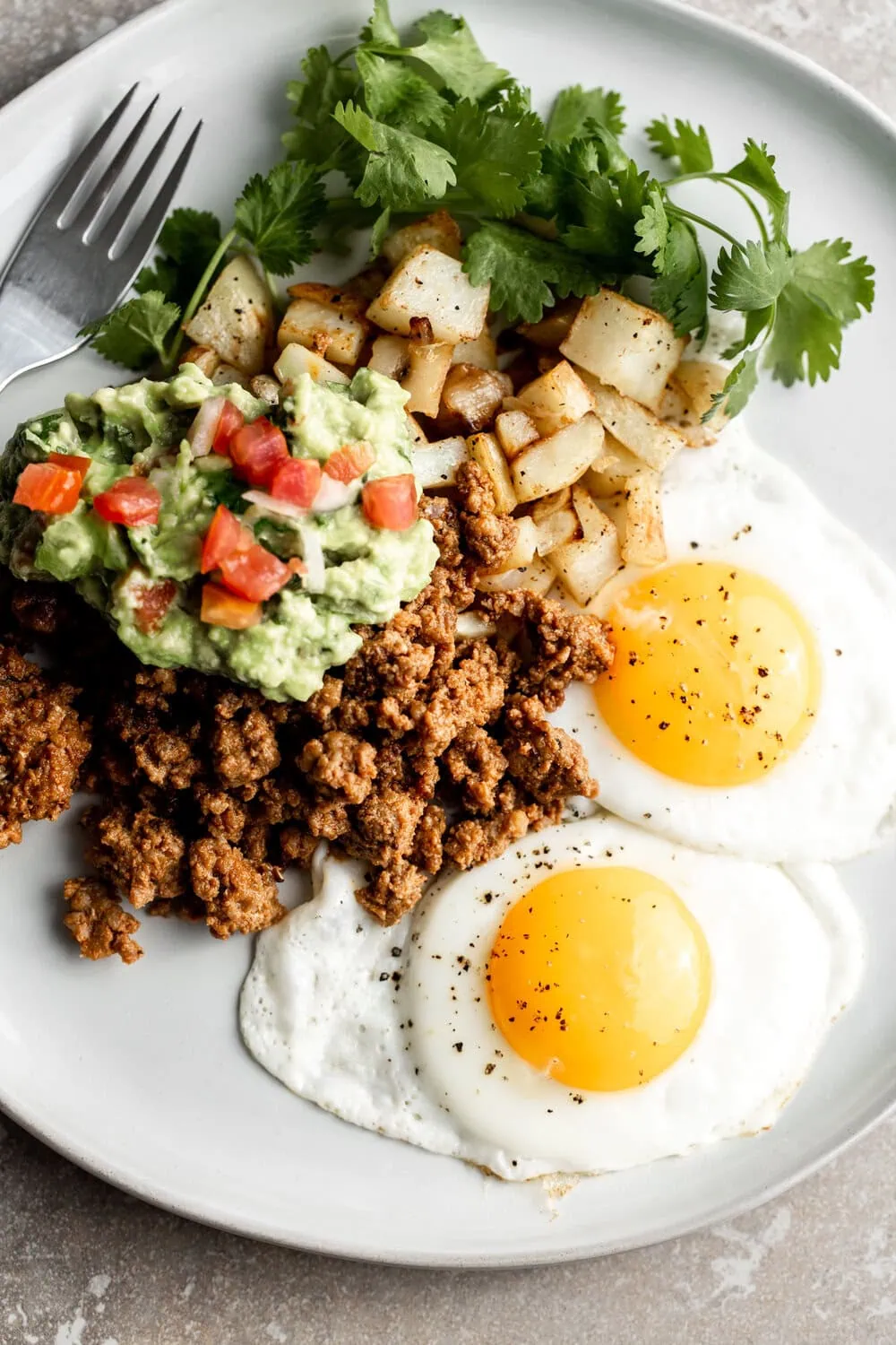 dad's breakfast potatoes with chorizo and eggs closeup
