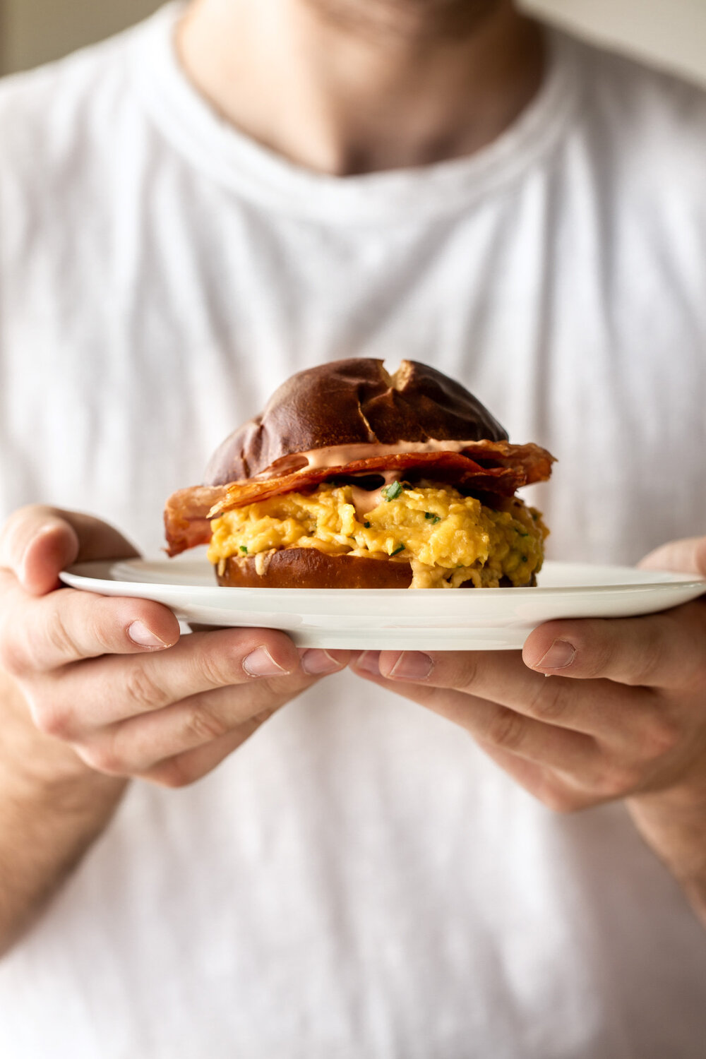 Egg, Cheese & Crispy Prosciutto Breakfast Sandwich on a Pretzel Bun