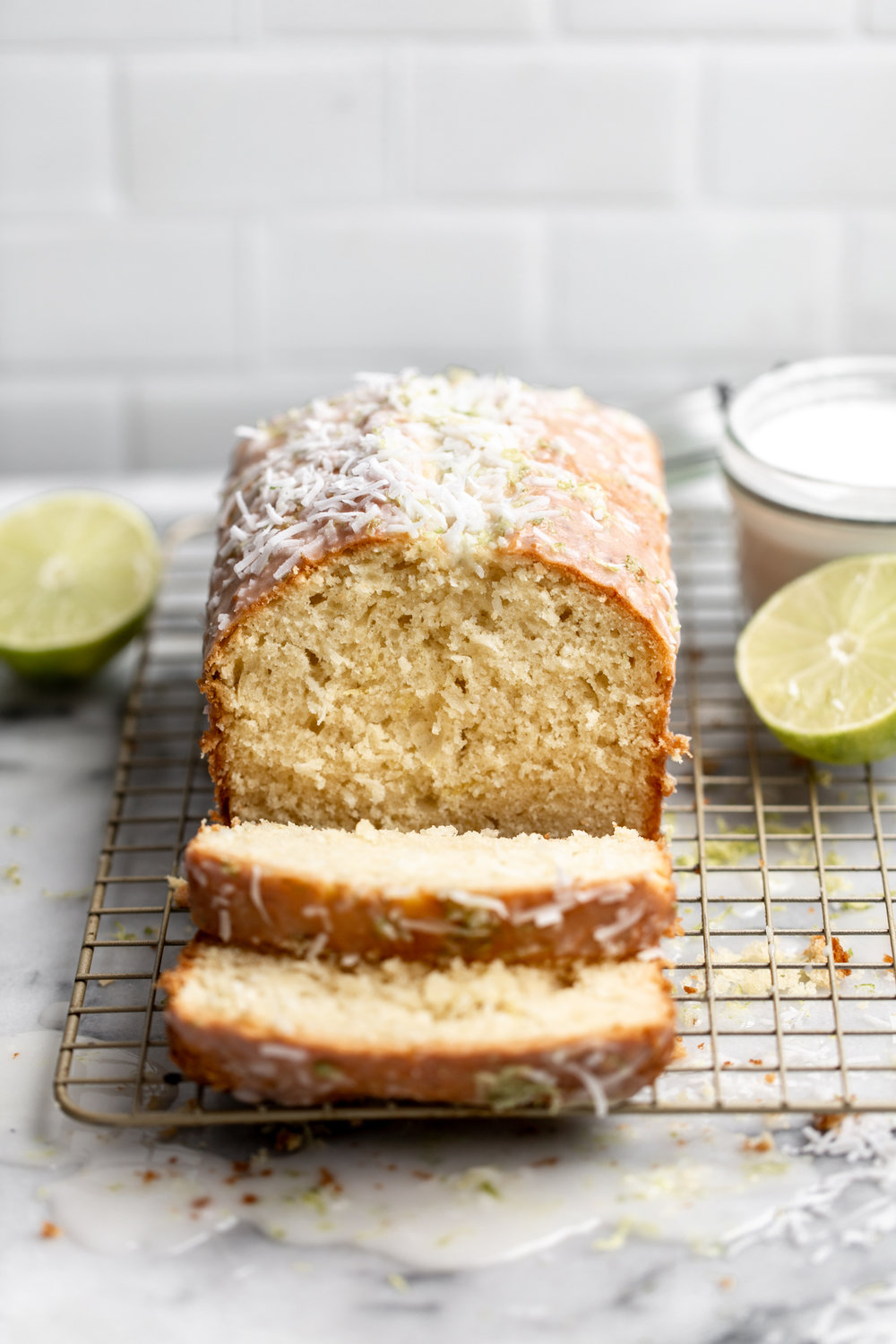 coconut lime bread sliced with drizzle and shredded coconut and lime zest from cooking with cocktail rings