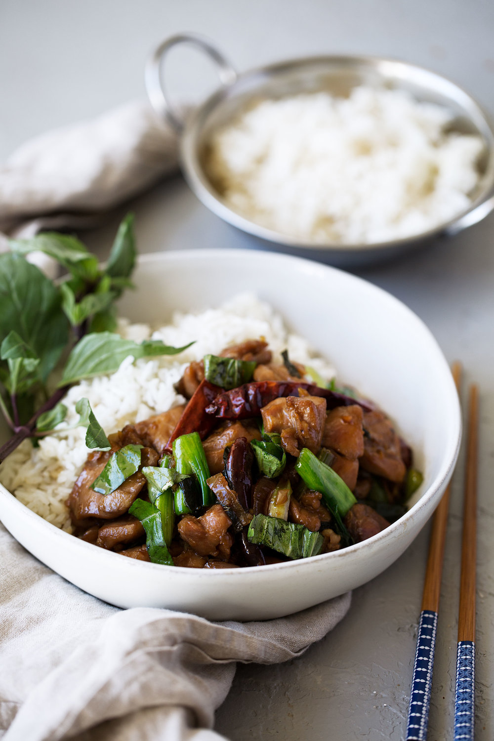 three cup chicken recipe over white rice with basil green onions and peppers