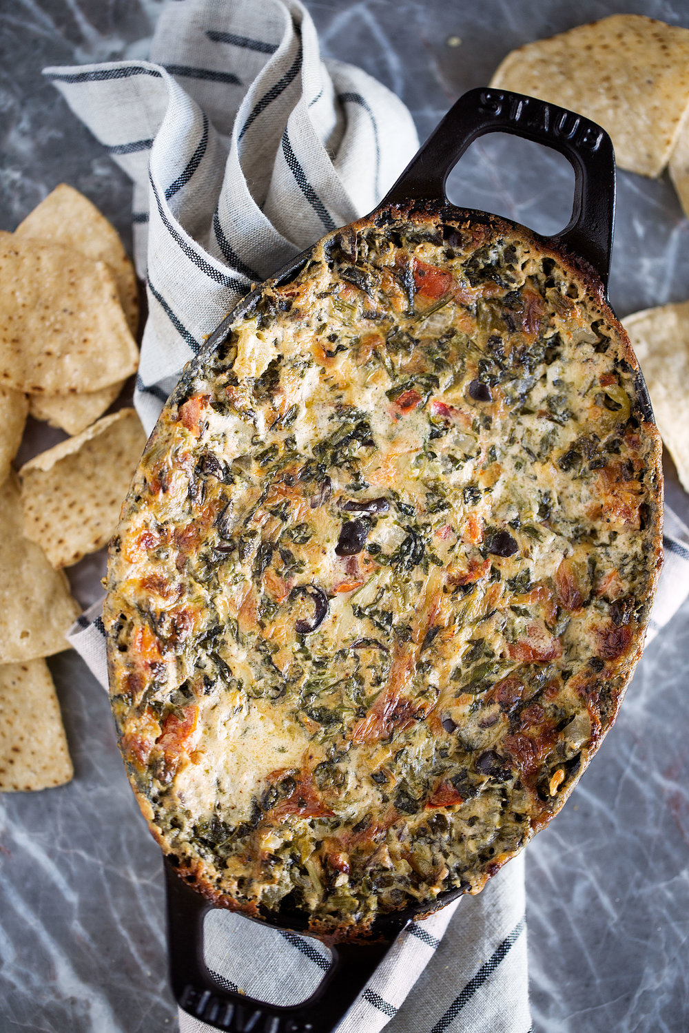 This cheesy hot spinach dip recipe is filled with tomatoes, green chilies and tomatoes combines Mexican flavors for a crowd-pleasing appetizer