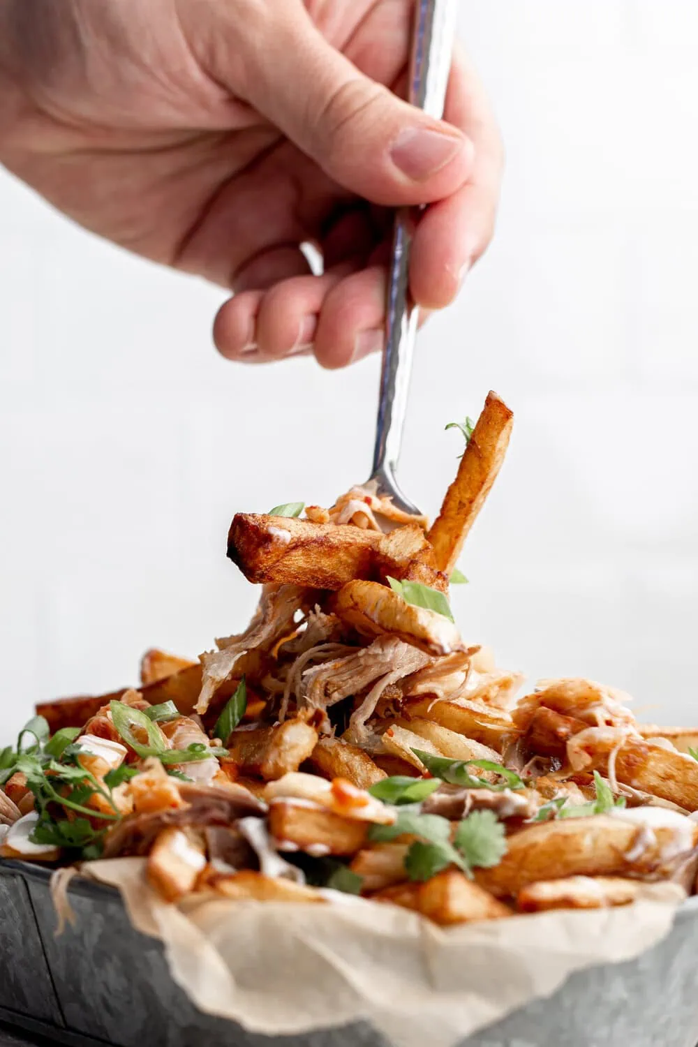 Duck Fat Fries with Duck Confit & Kimchi recipe from cooking with cocktail rings closeup