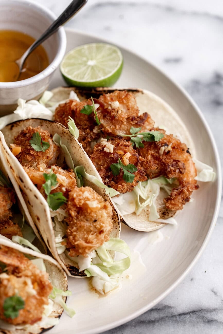 Fried, crispy coconut shrimp drizzled in a spicy habanero lime butter corn tortillas tacos.