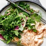 olive oil poached salmon in a grey stone bowl with fennel fronds and herbs