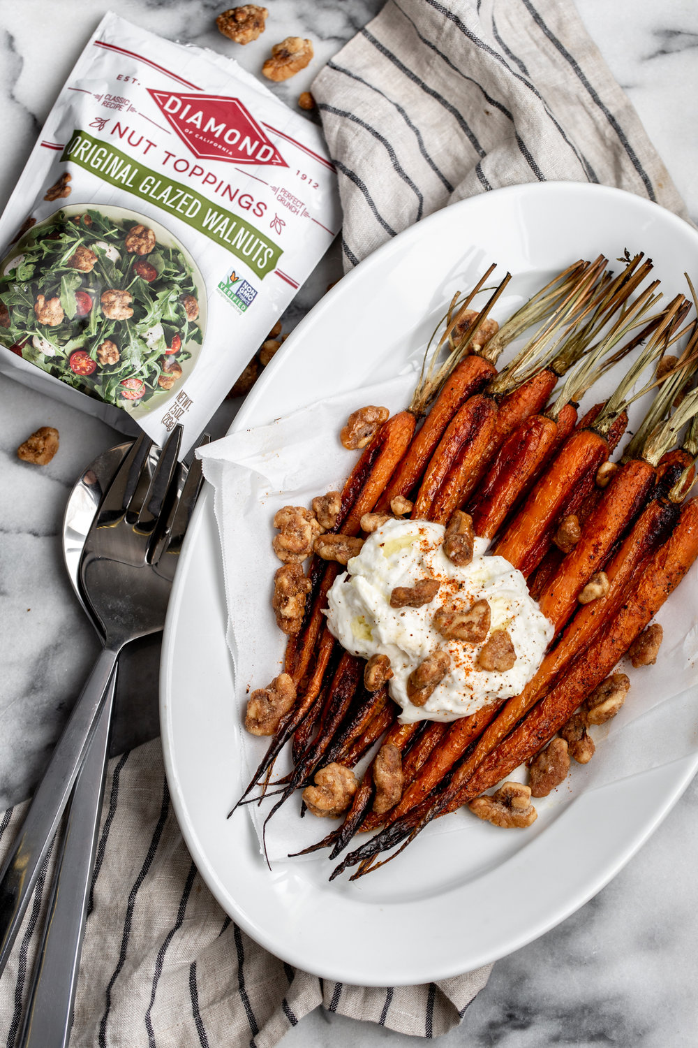 The roasted carrots are seasoned simply with salt, pepper and a touch of cayenne for a bit of spice then topped with creamy burrata cheese and some crispy, glazed walnuts
