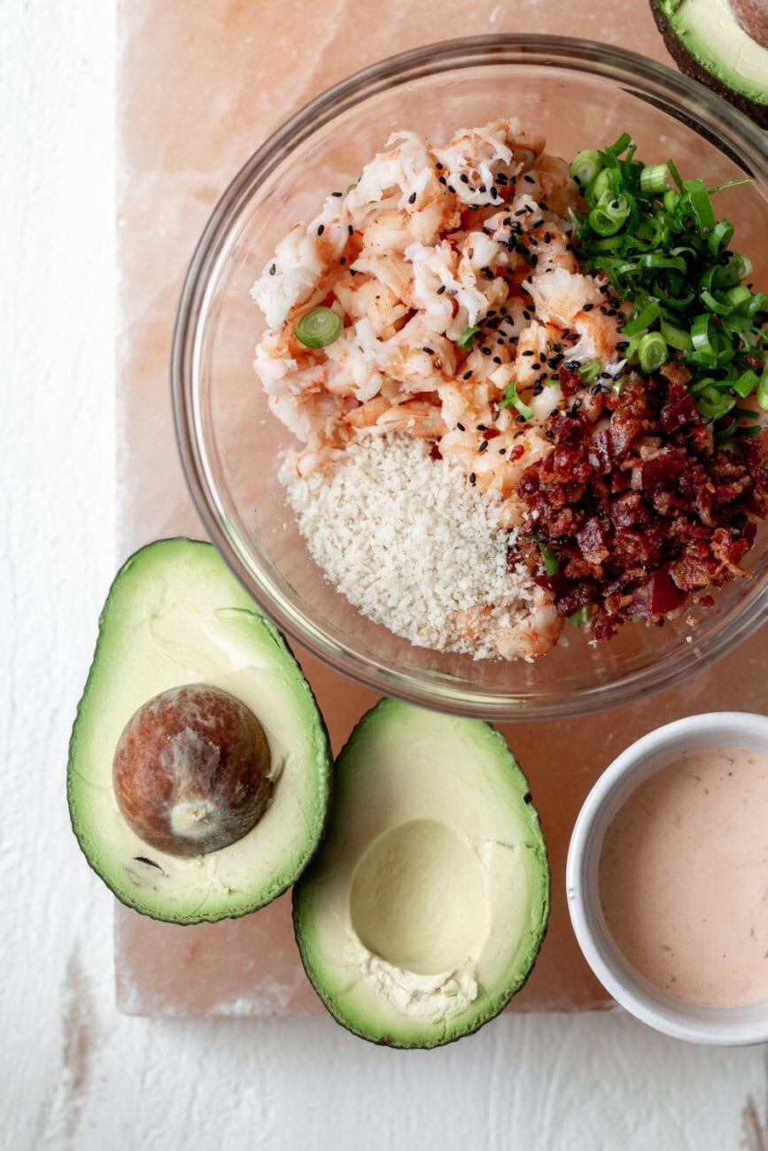 stuffed avocado filling with diced shrimp bacon and green onion in spicy mayonnaise.