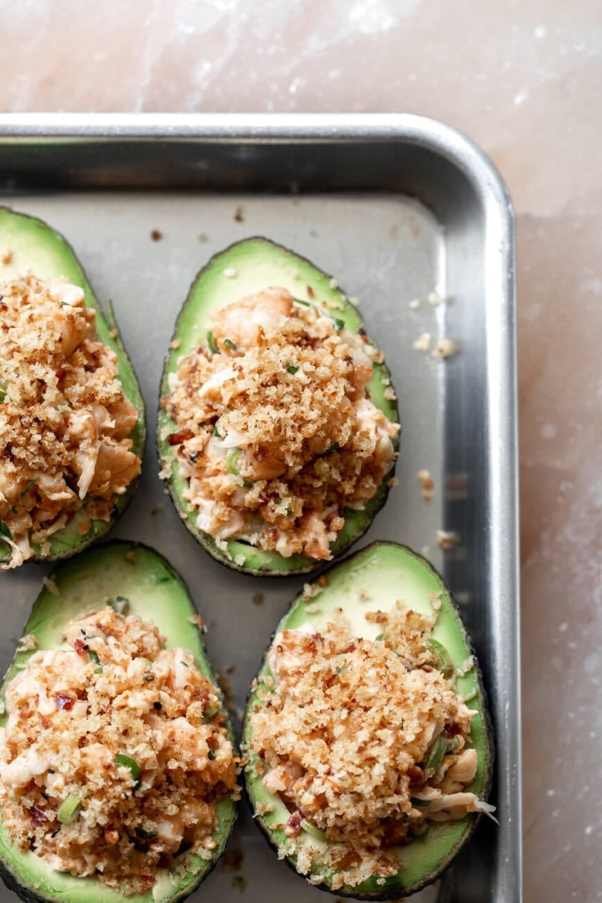 stuffed avocados on baking sheet to broil.