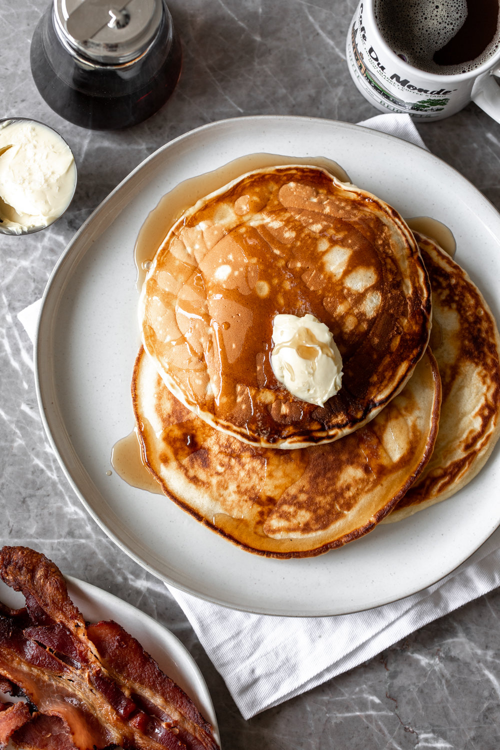 stack of Diner-Style Pancakes with butter and maple syrup on plate