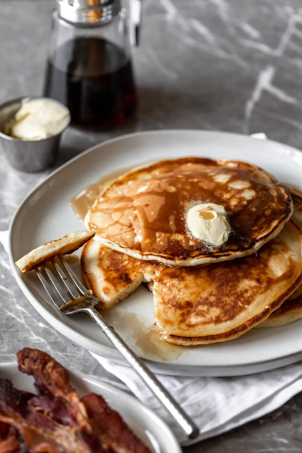 Diner-Style Pancakes with knife and fork cut piece
