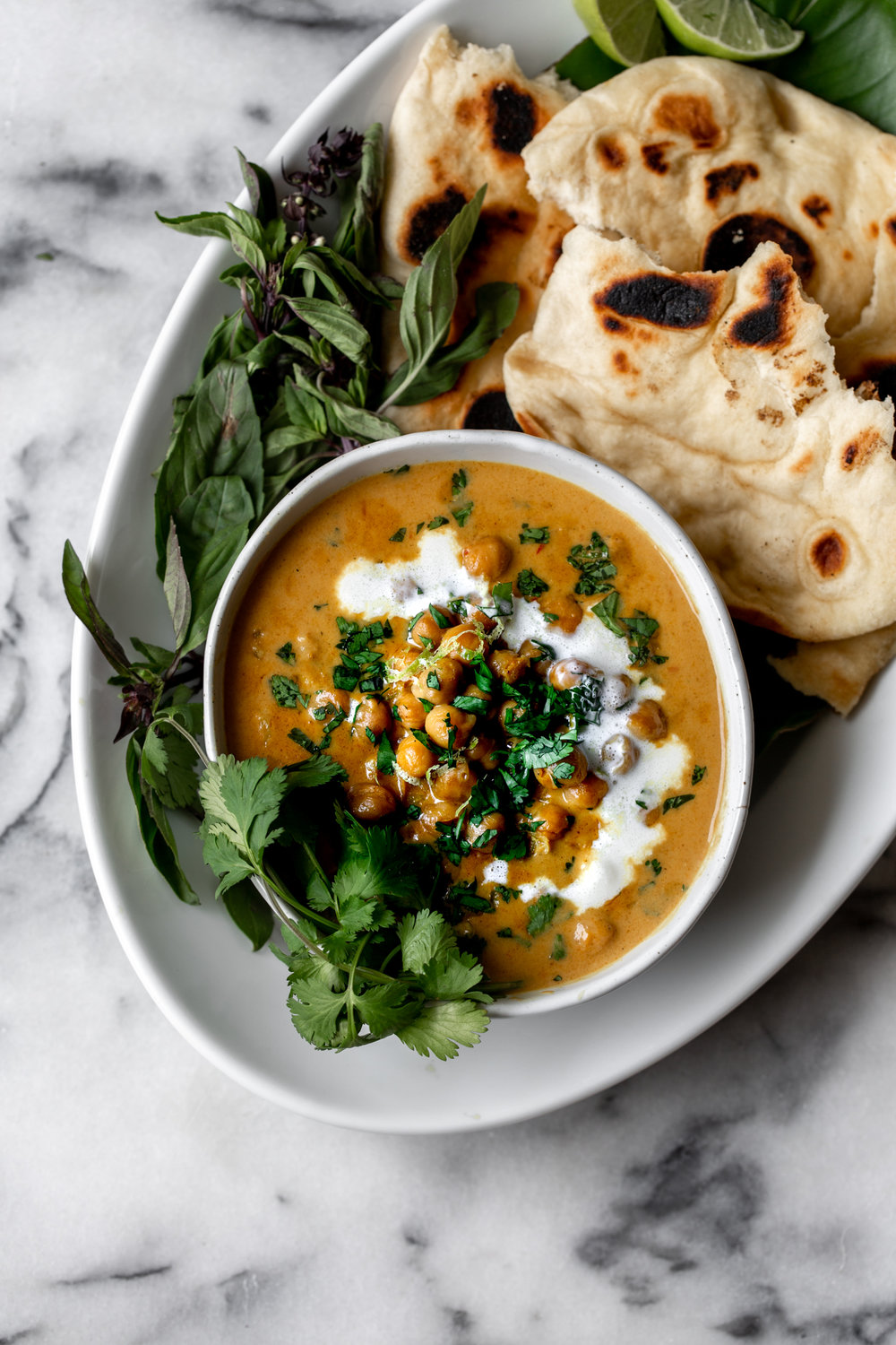 Chickpea Coconut Curry recipe with naan bread and herbs