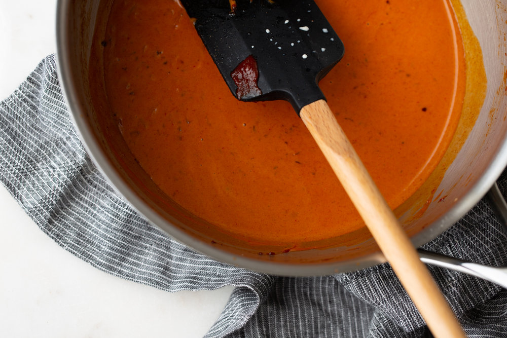 Creamy Gochujang sauce bright red with spatula