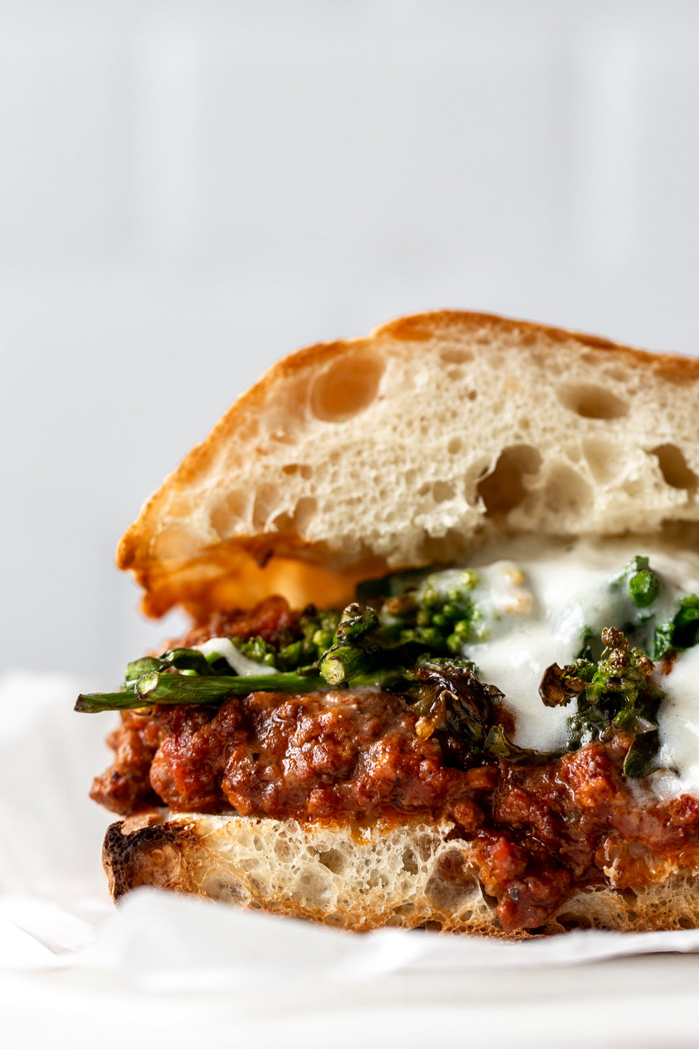 Italian Sloppy Joe Sandwich made with bolognese, rapini and burrata on ciabatta bread