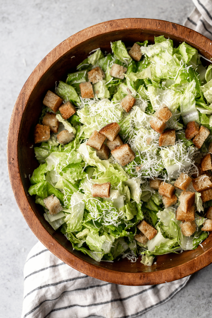 how to make tableside caesar salad with chili oil croutons GIF