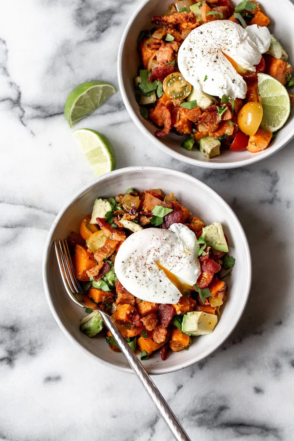 sweet potato breakfast hash with crispy bacon, avocado, tomato and topped with poached egg