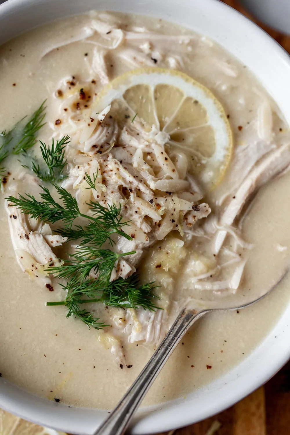 Greek Lemon-Egg Chicken Soup (Avgolemono) garnished with lemon dill and chicken