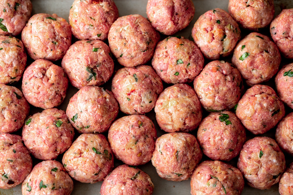 raw spicy beef and pork meatballs ready for oven