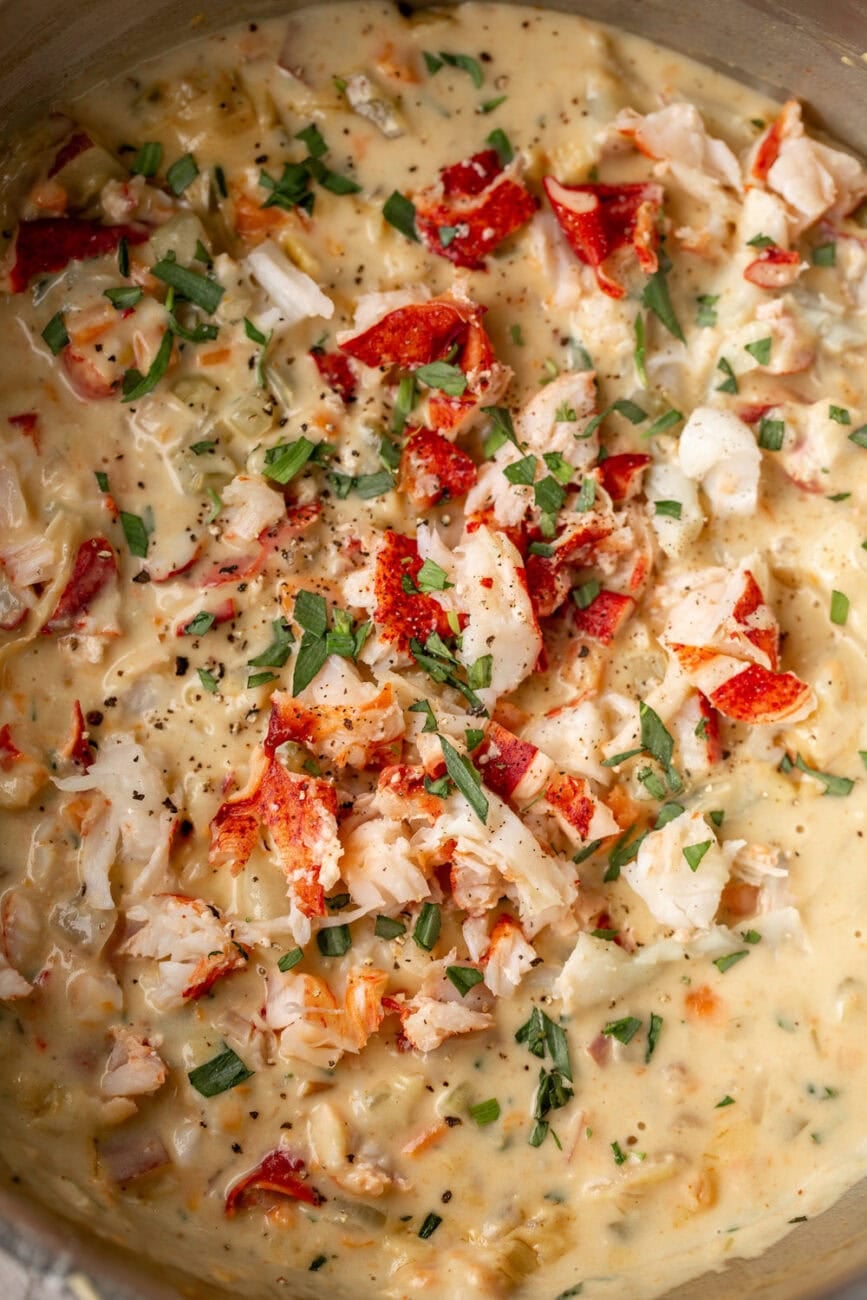 creamy lobster pot pie filling in pot with tarragon.