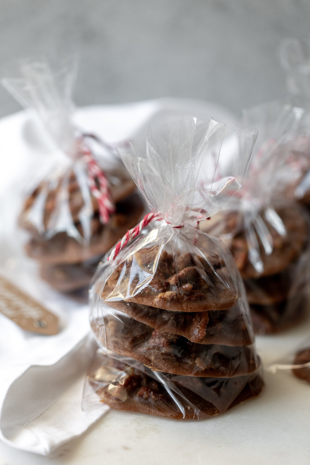 Creamy Bananas Foster Pecan Pralines recipe wrapped in cellophane holiday gift
