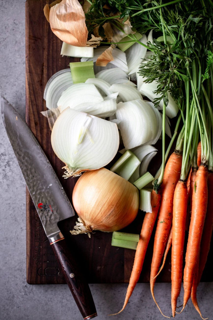 halved onions with carrots and celery.