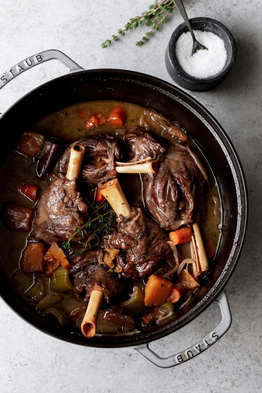 Red Wine Braised Lamb Shanks with Butternut Squash in pot recipe in Dutch oven.