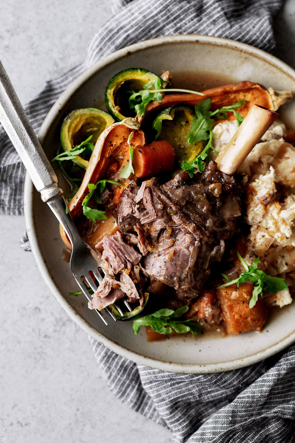Red Wine Braised Lamb Shanks with Butternut Squash recipe in bowl with fork