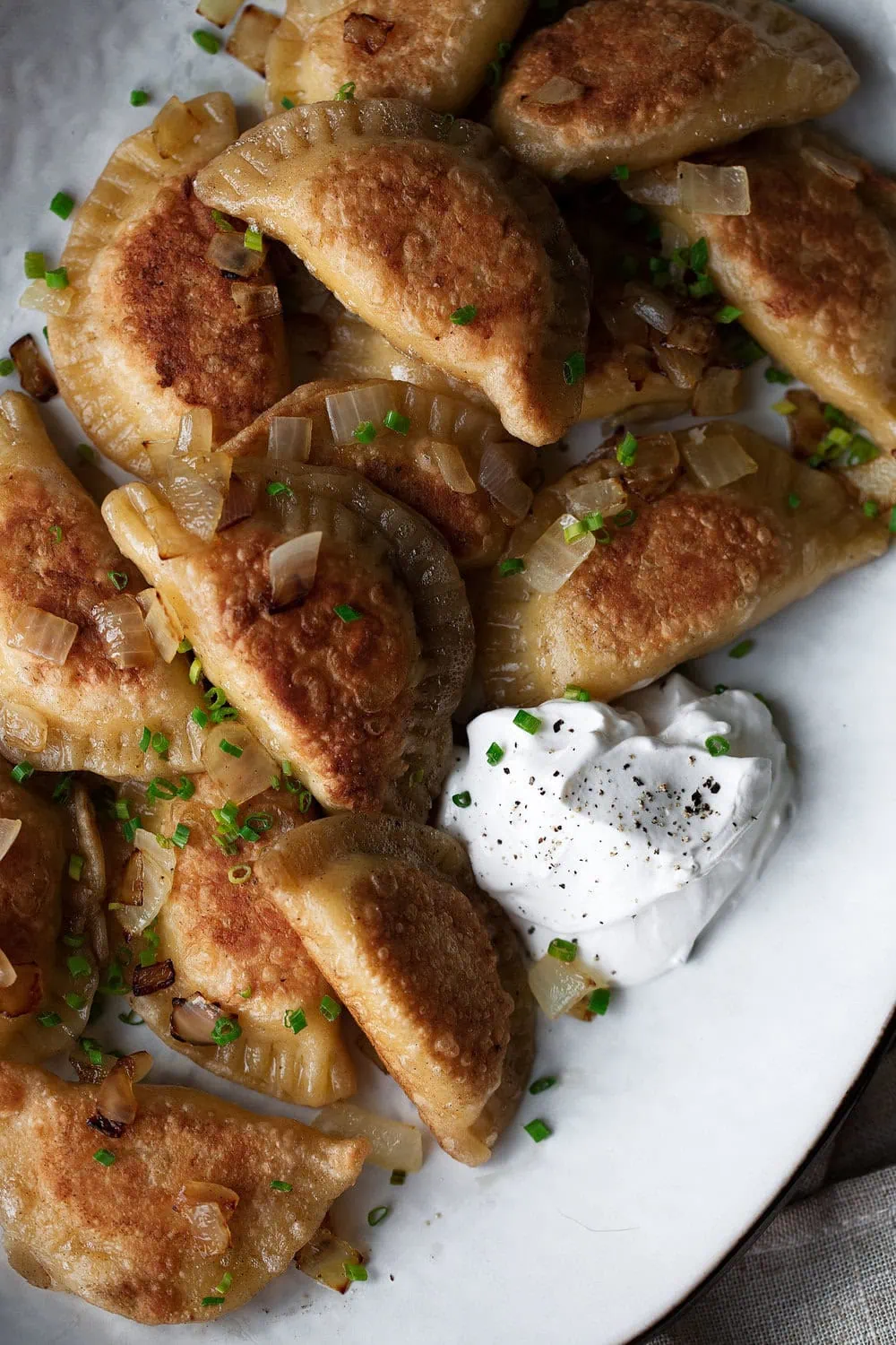 Pierogi are like a polish with sour cream dough stuffed with a cheesy potato mixture boiled then pan-fried