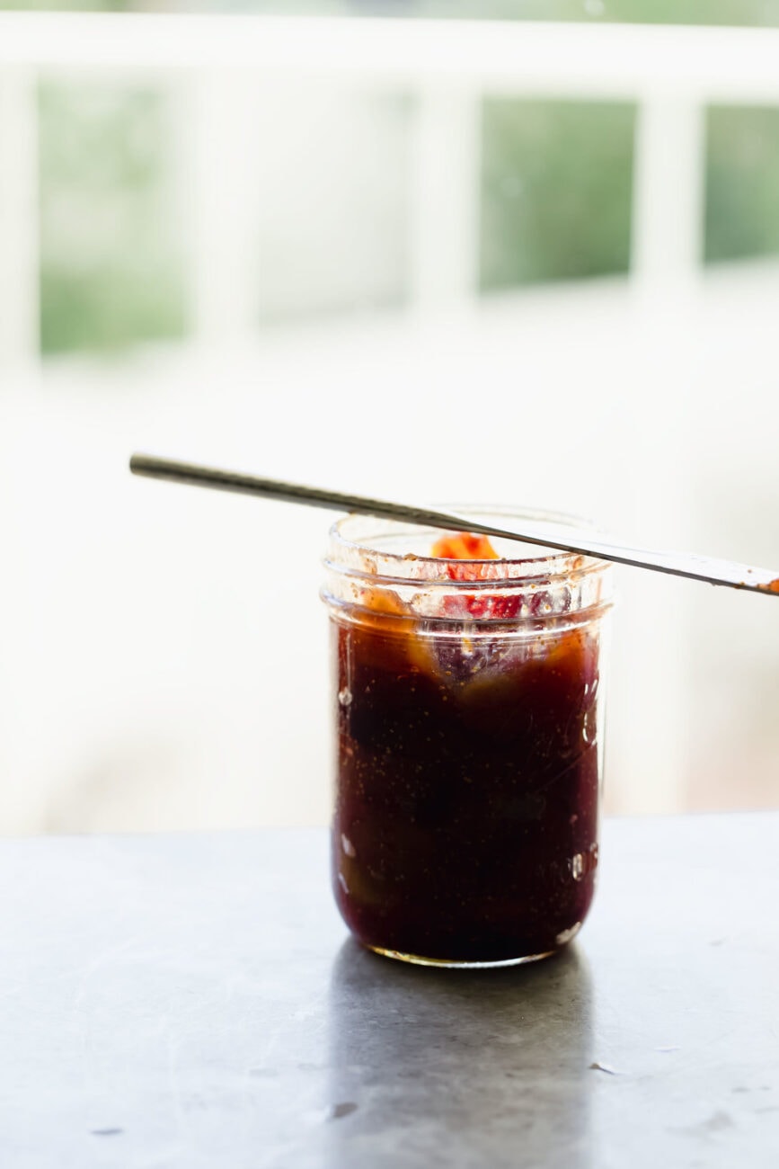 jar of fig jam with knife balanced on top. 