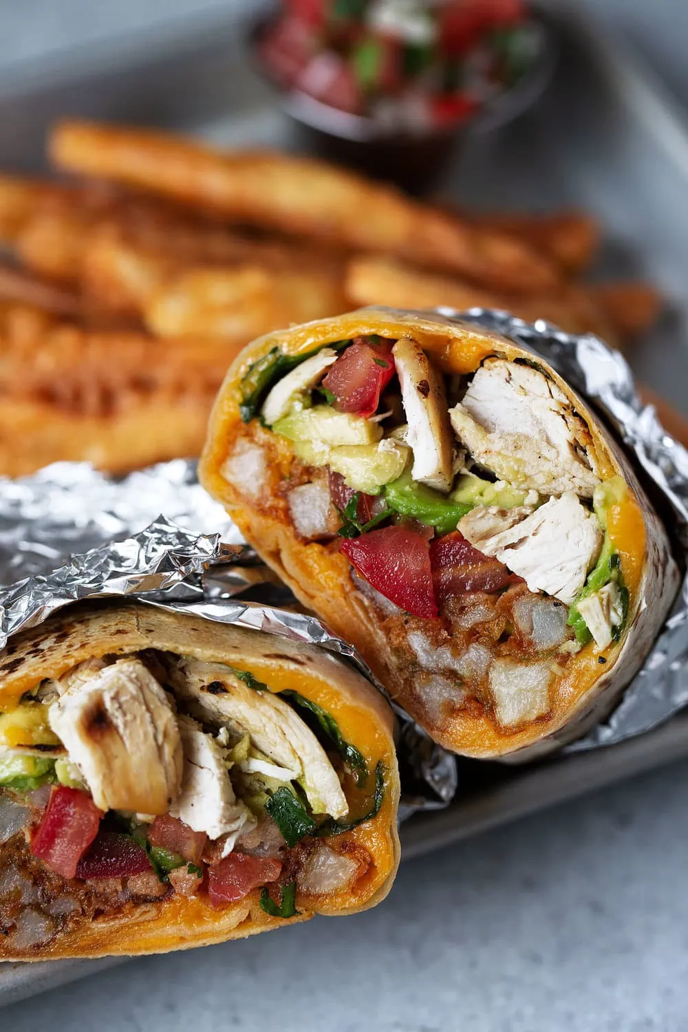 california chicken burrito with seasoned fries cooking with cocktail rings wrapped in foil