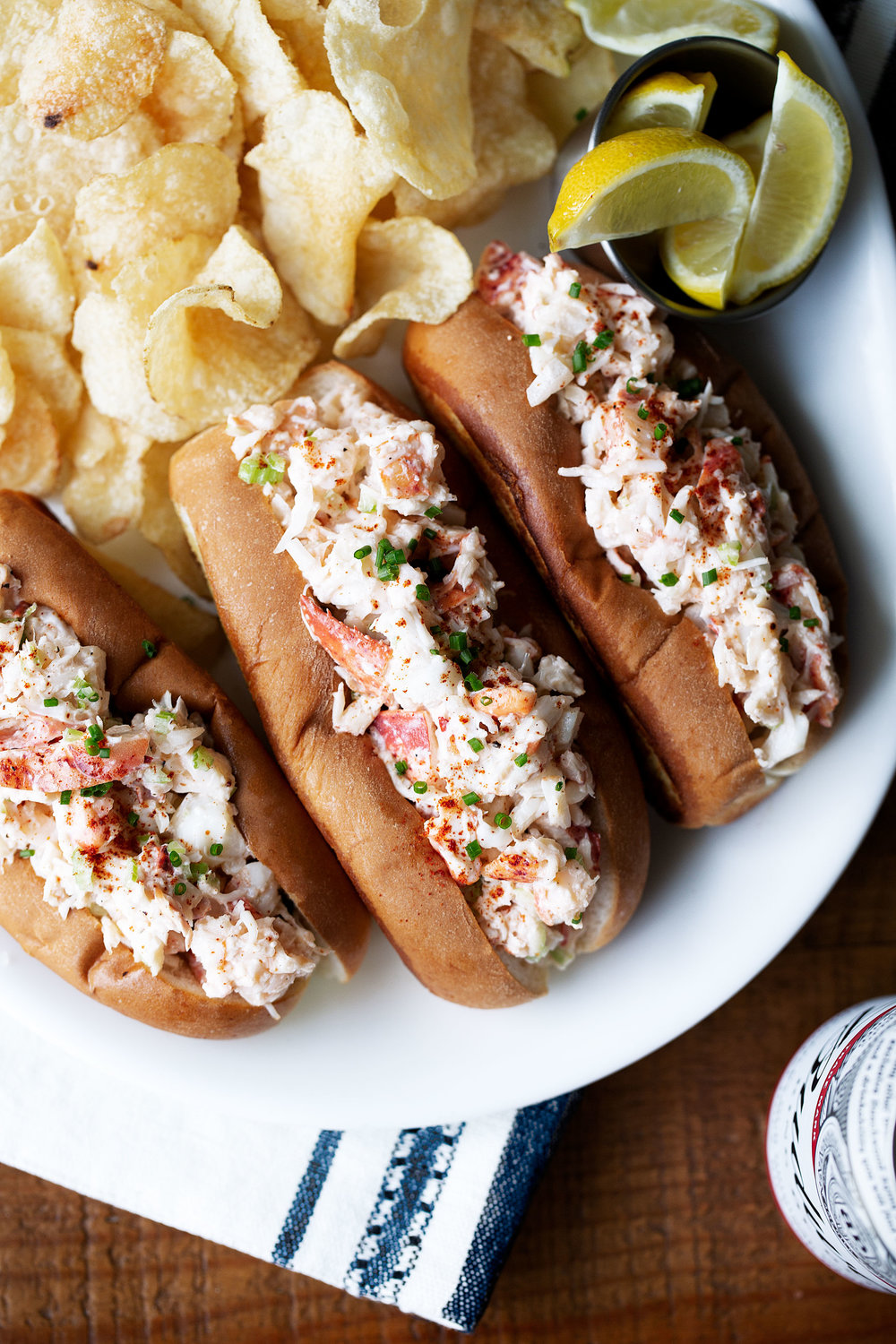 new england style lobster roll in toasted buns with lemon wedges