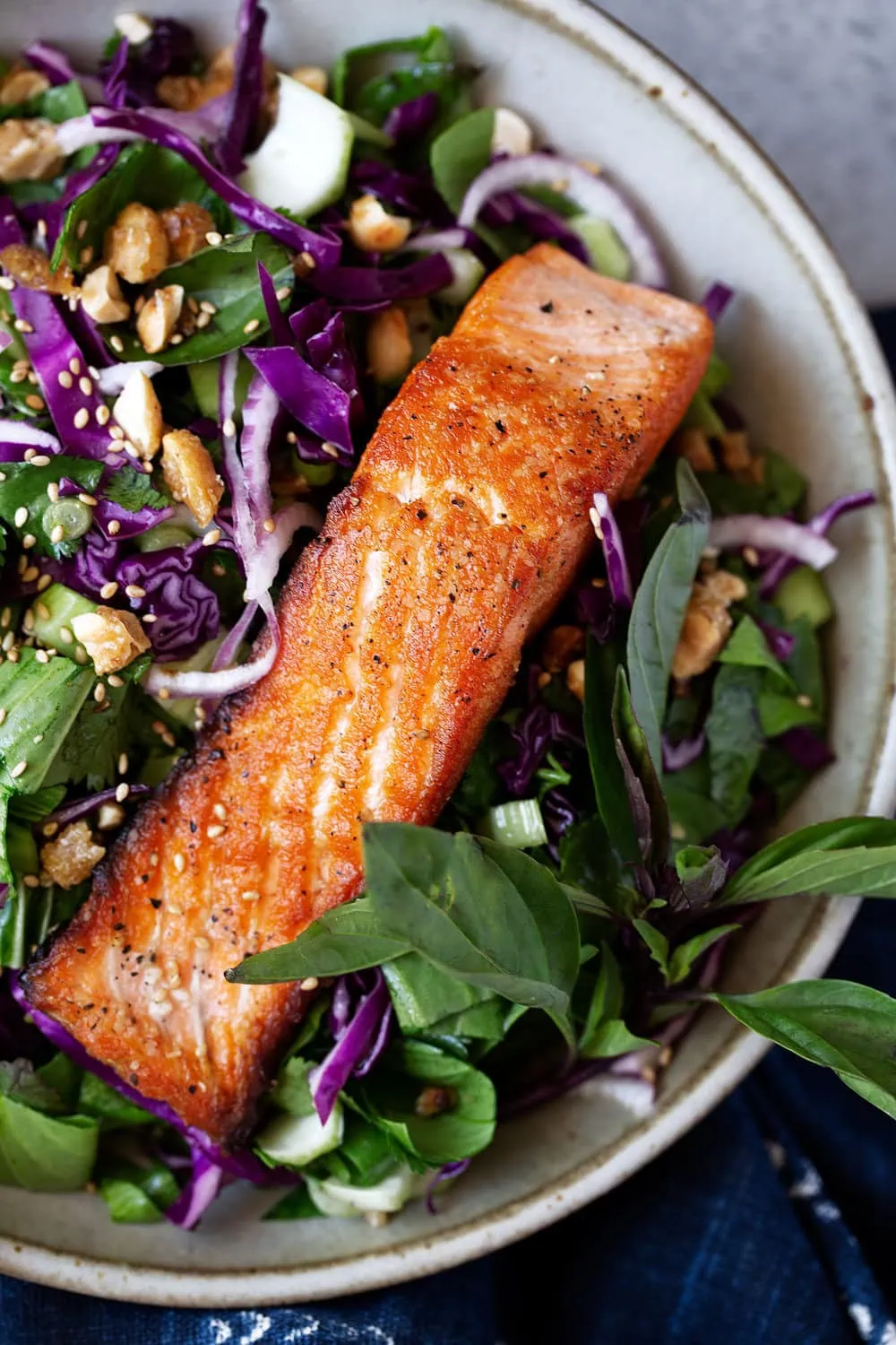 Crispy seared salmon over bok choy and cabbage with Thai dressing topped with candied peanuts.