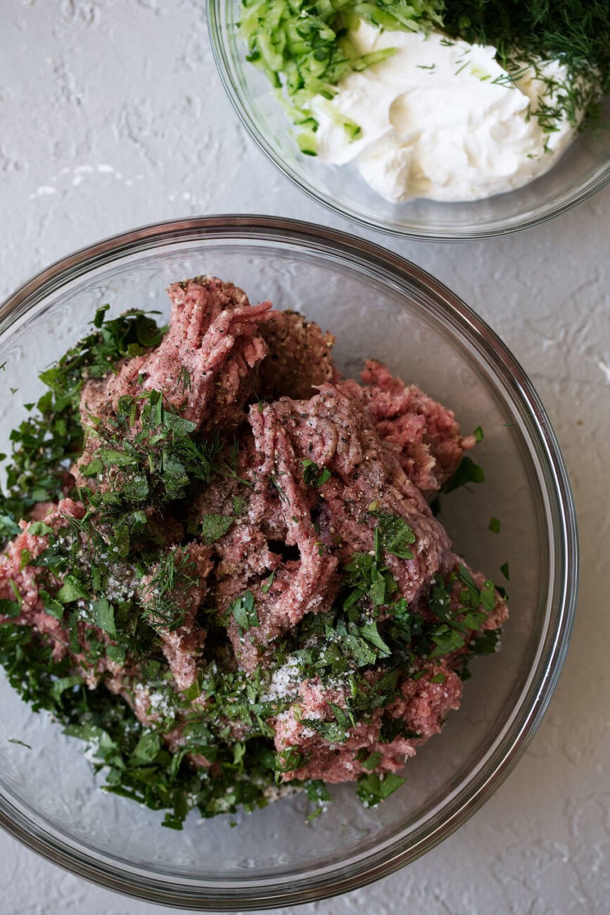 lamb with herbs in mixing bowl.