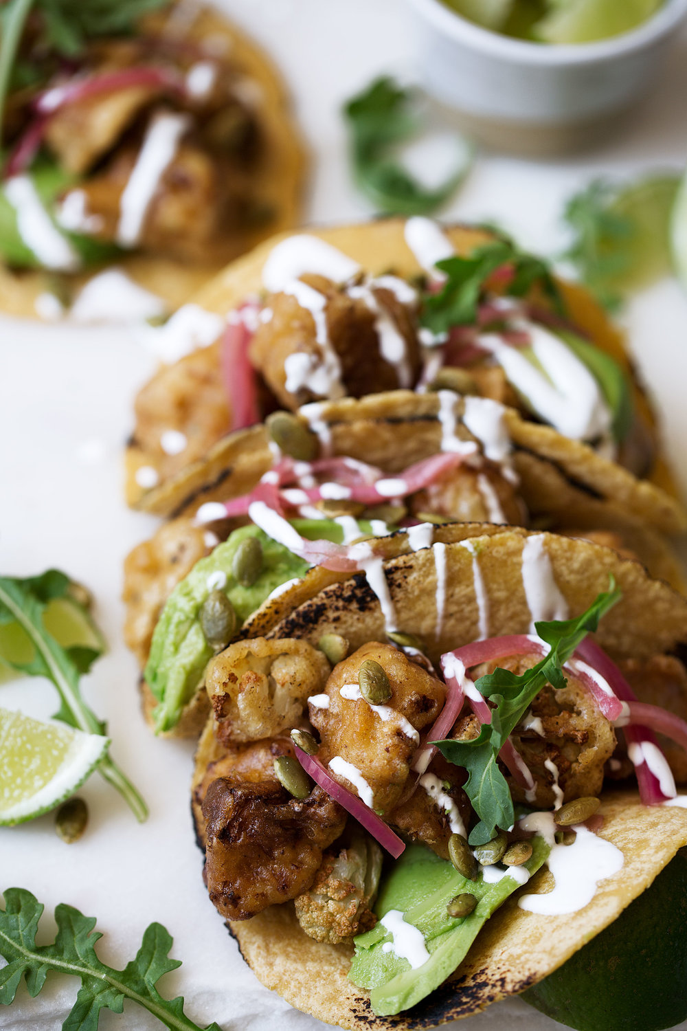 roasted cauliflower and avocado tacos with pickled onions and arugula