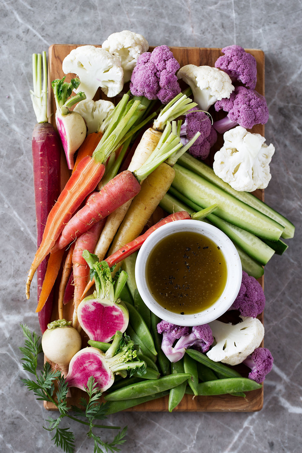 Bagna Cauda is a dish from the Piedmont region of Northwest Italy made with olive oil, garlic and anchovies and served with raw vegetables - cauliflower, carrots, cucumber and watermelon radish