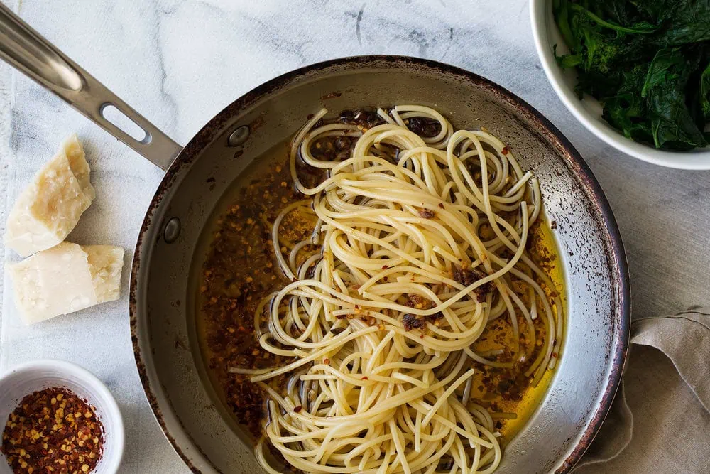 spaghetti with anchovy and chili oil in sauté pan