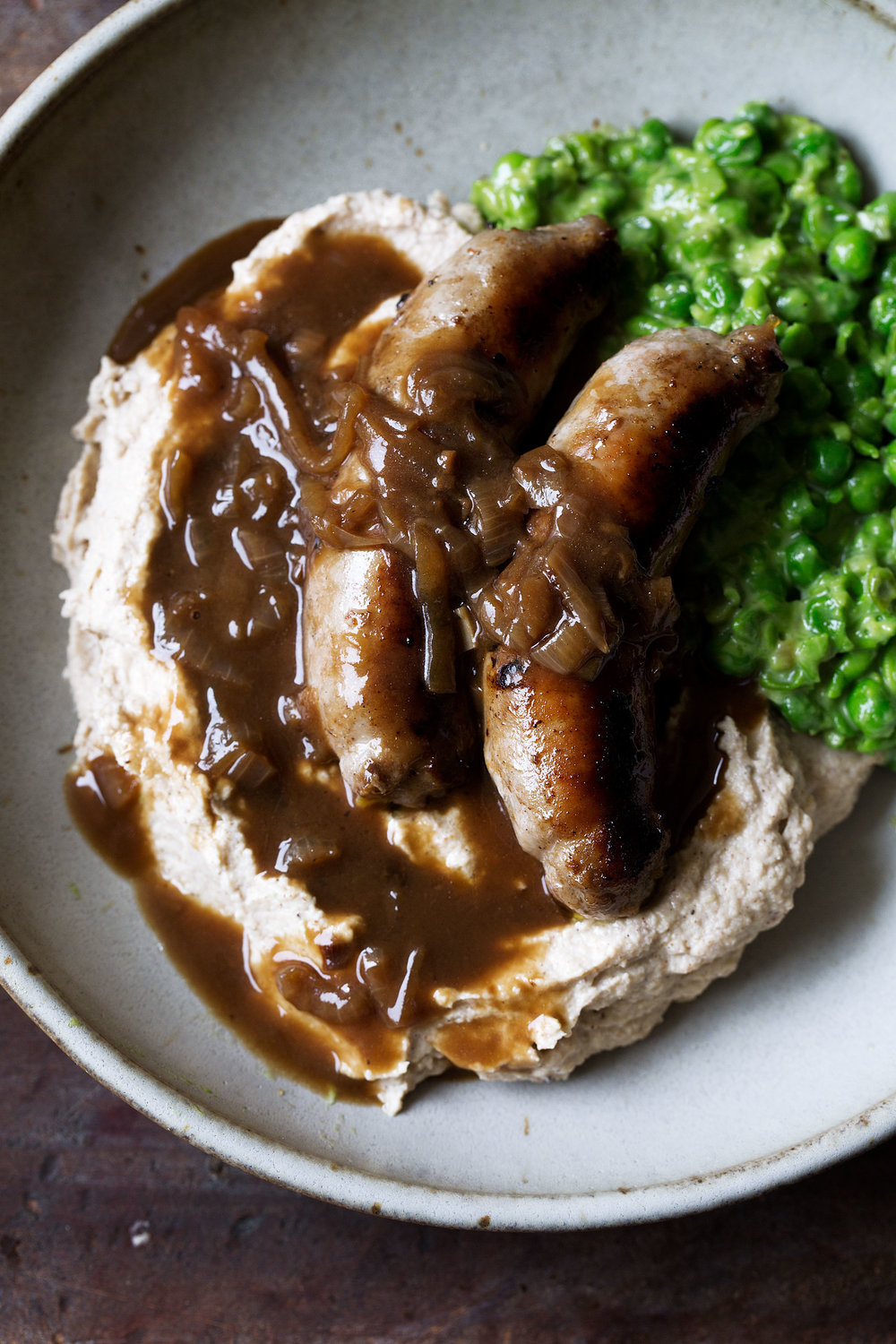 bangers and cauliflower mash with guinness onion gravy and mushy peas recipe from cooking with cocktail rings