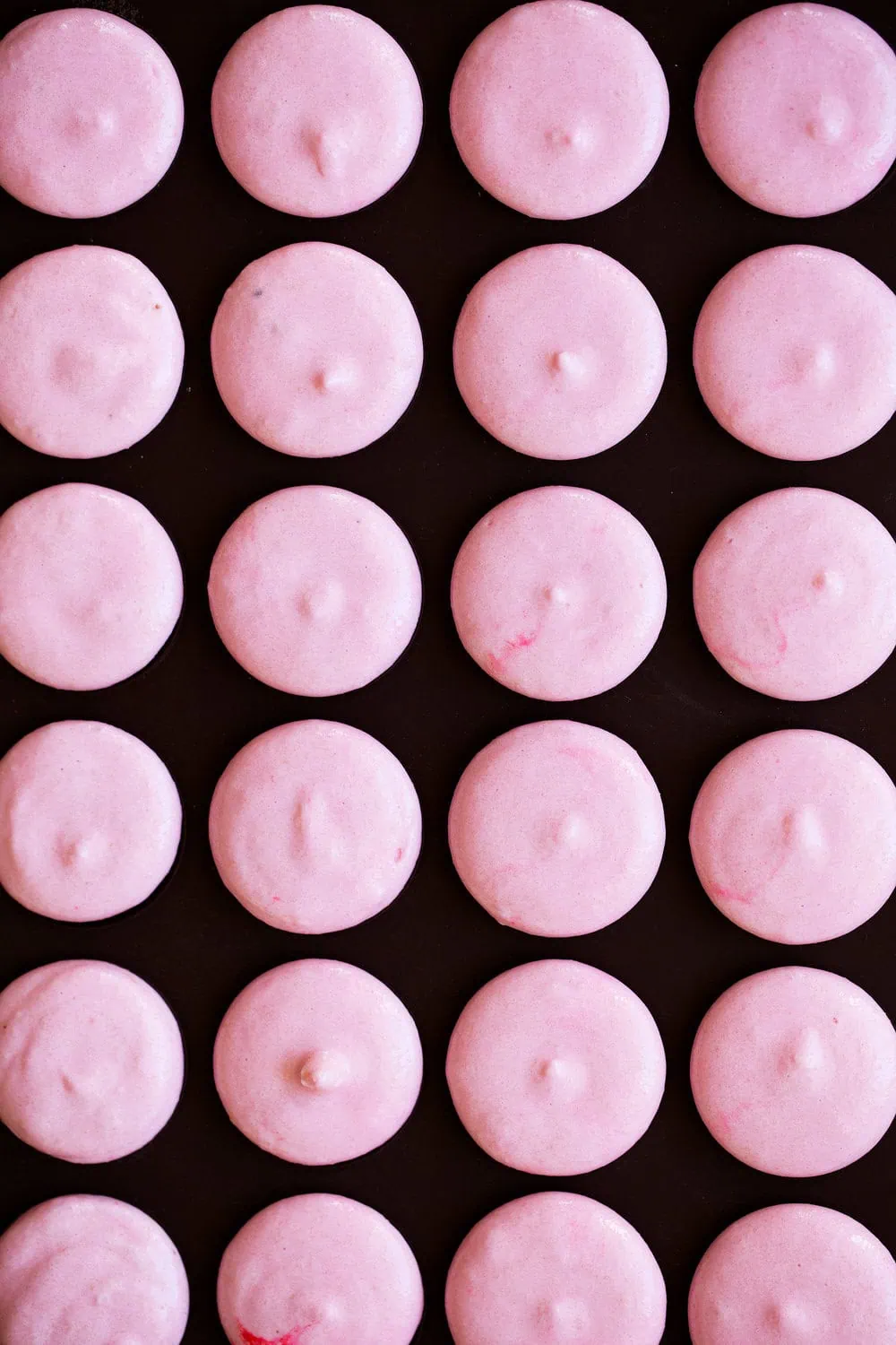 piped strawberry macarons batter cooking with cocktail rings