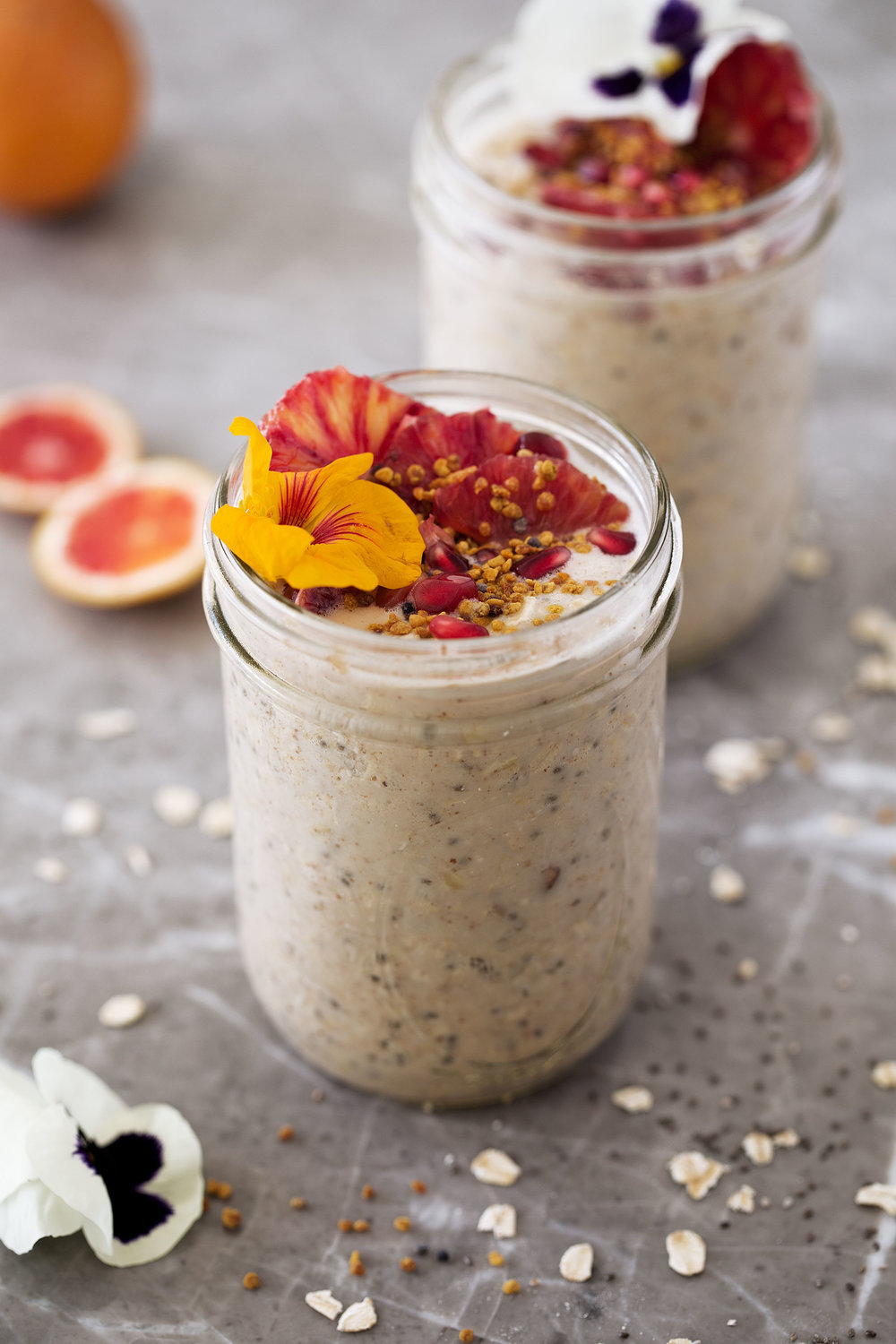 almond butter overnight oats with chia seeds and edible flowers in mason jars