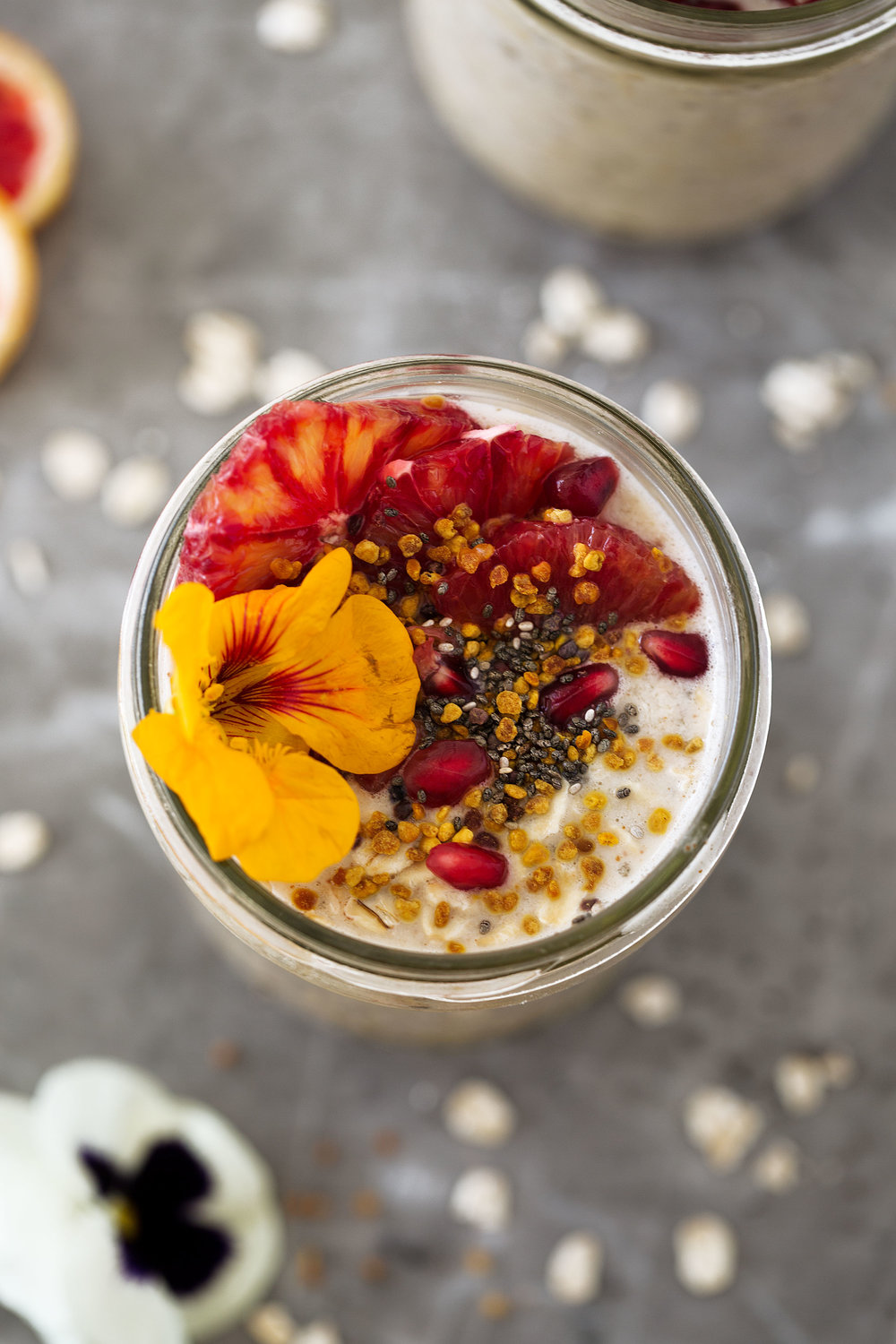 almond butter overnight oats with chia seeds and edible flowers and pomegranate seeds