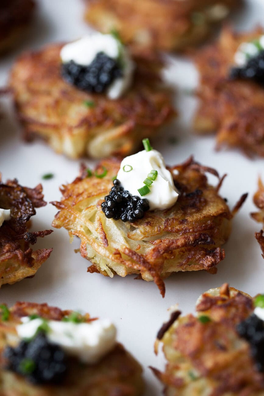 mini fancy latkes topped with creme fraiche and caviar.