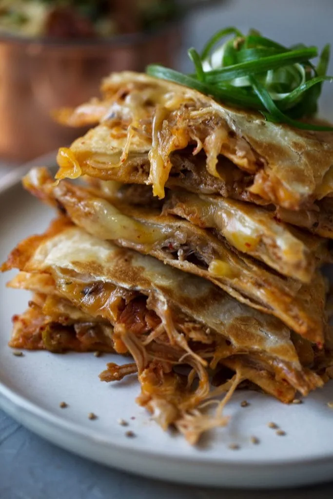 Korean Braised Pork and Kimchi Quesadilla slices stacked.